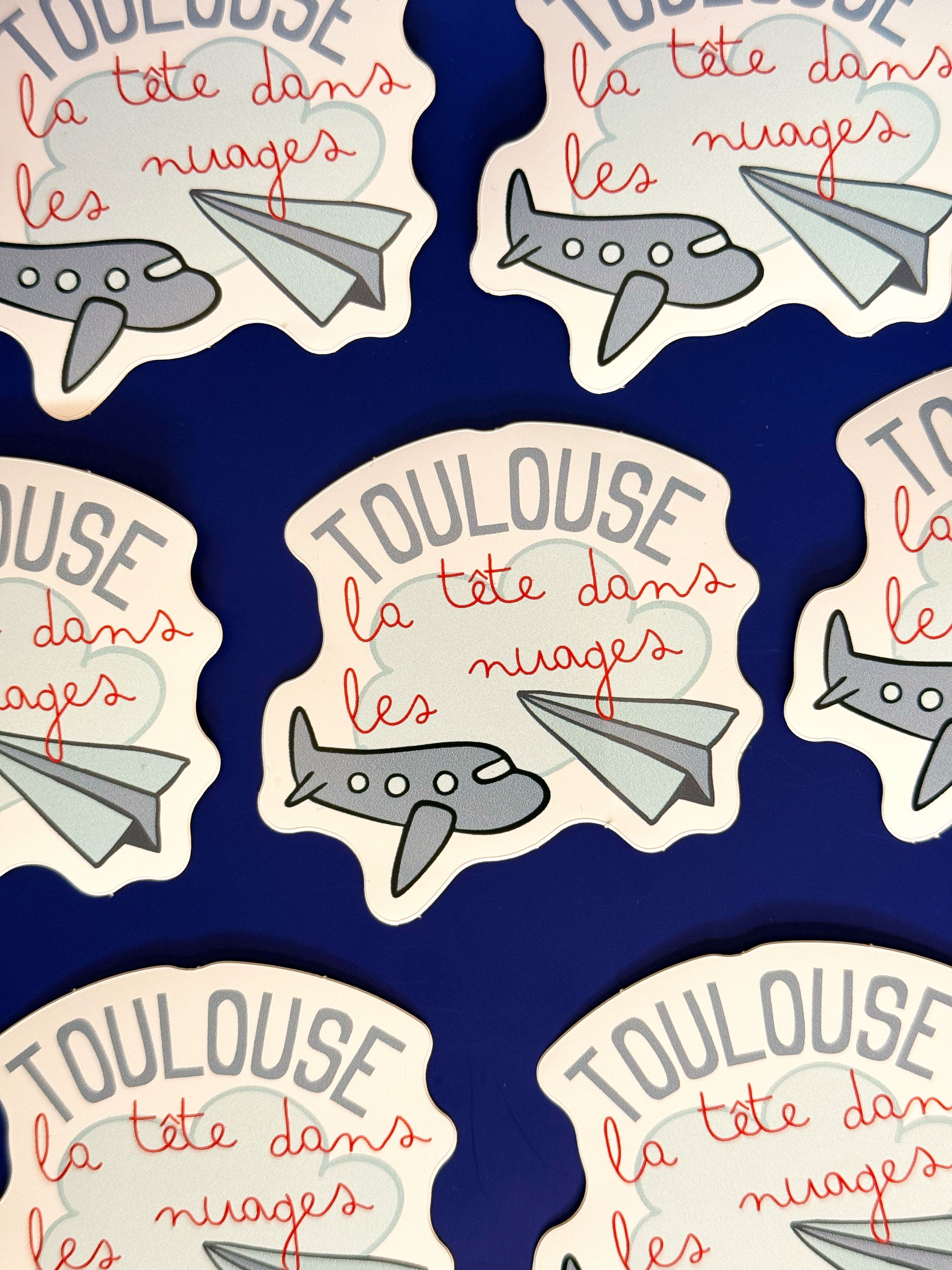 Sticker Toulouse la tête dans les nuages avec avions illustrés

