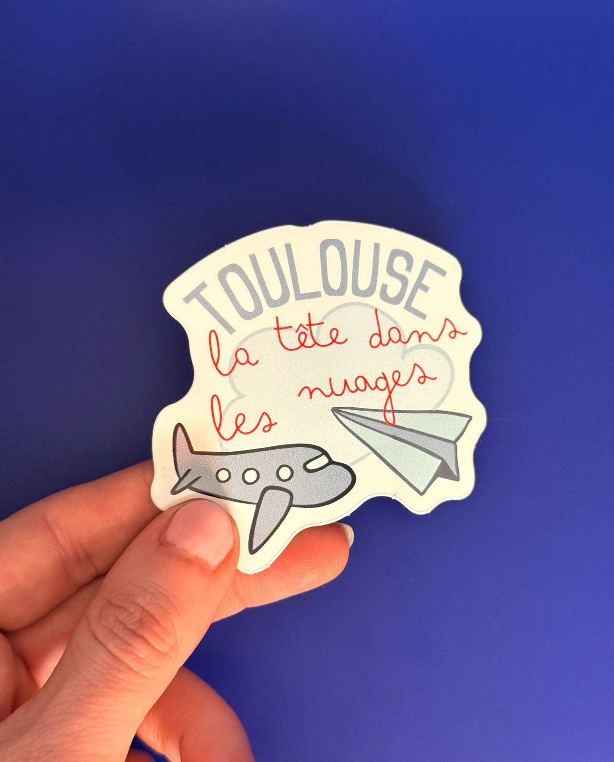Sticker Toulouse la tête dans les nuages avec avions illustrés
