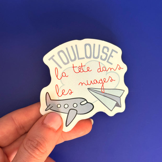 Sticker Toulouse la tête dans les nuages avec avions illustrés
