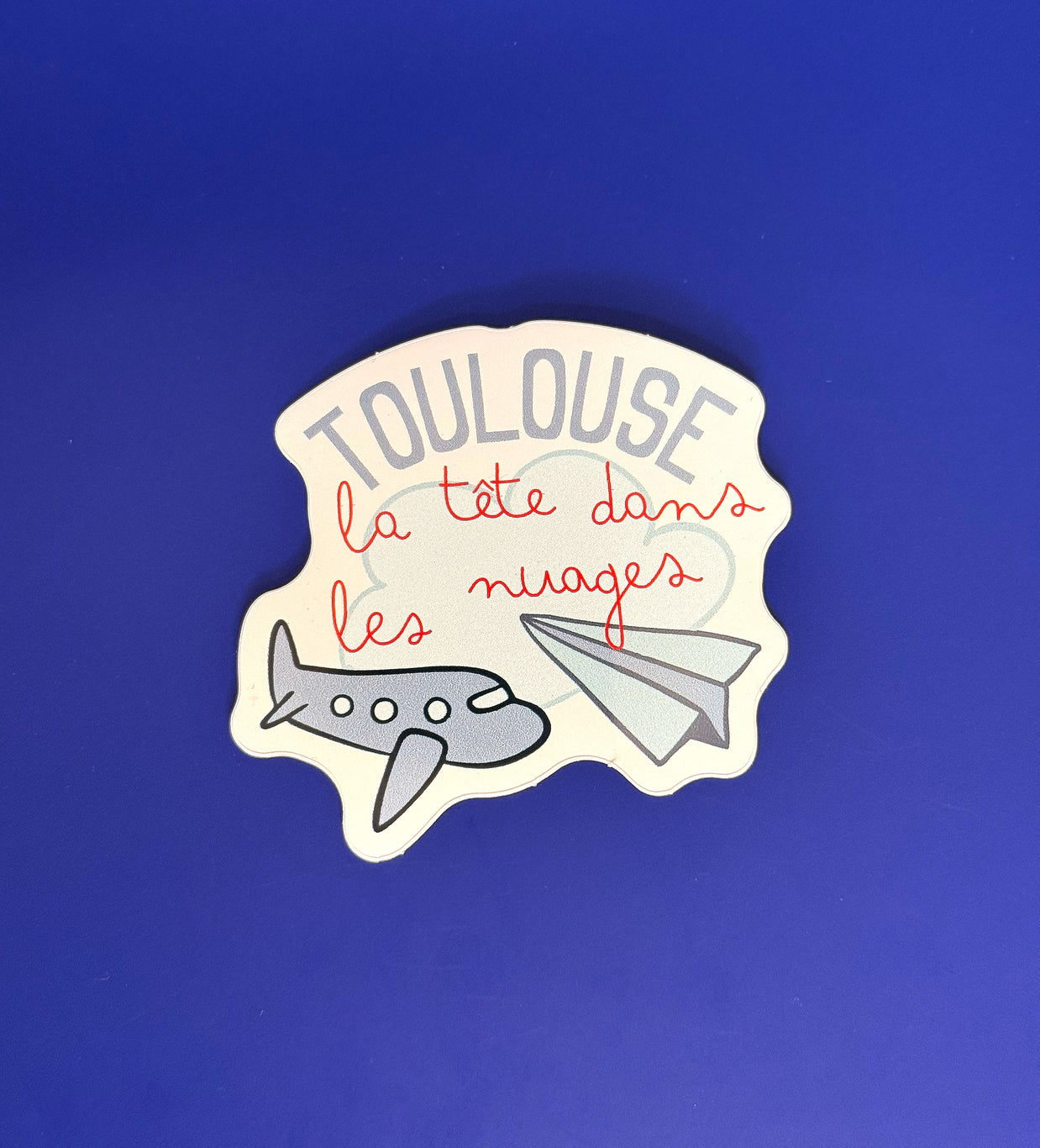 Sticker Toulouse la tête dans les nuages avec avions illustrés
